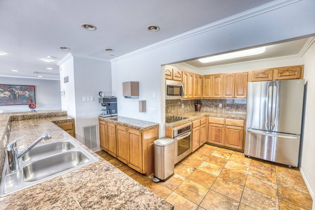 a large kitchen with a round ceiling and wood cabinets at Juniper Springs Apartments, Austin, TX